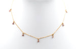 The 7-stone pink choker necklace.  Pink gemstones dangling from a dainty gold chain.