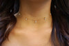 Seven-gem choker modeled on a woman with long hair.