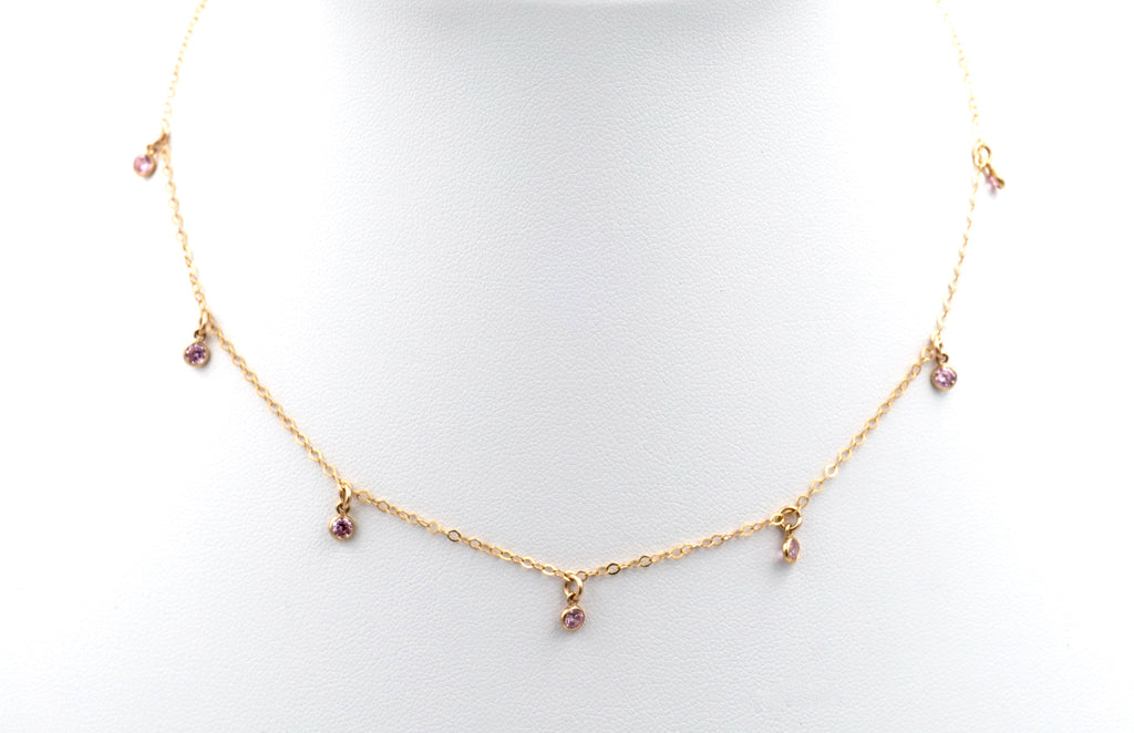 The 7-stone pink choker necklace.  Pink gemstones dangling from a dainty gold chain.