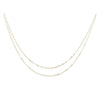 Two delicate gold layered flat cable chains.