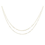 Two delicate gold layered flat cable chains.