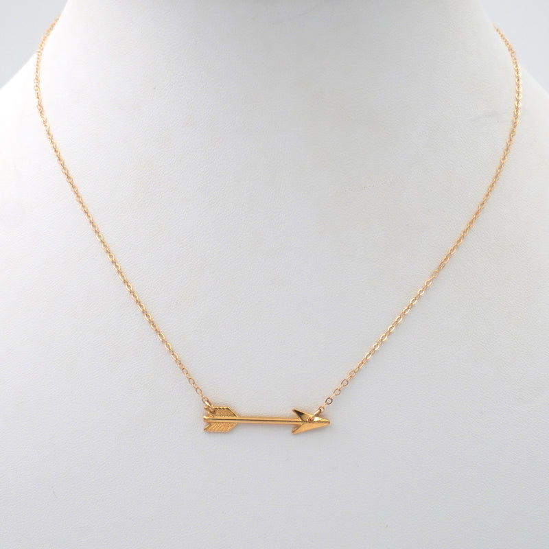 Gold chain with an arrow pendant.  